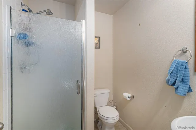 a white toilet sitting next to a bathroom