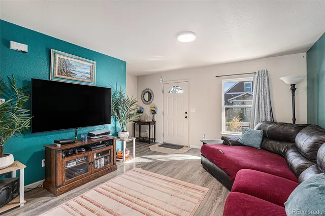 a living room with furniture and a flat screen tv