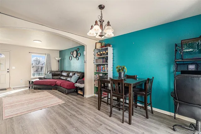 a living room with furniture a window and a chandelier