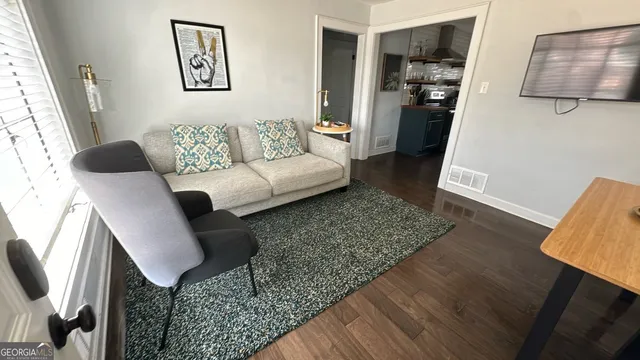 a front view of a building with retail shops and mountain view