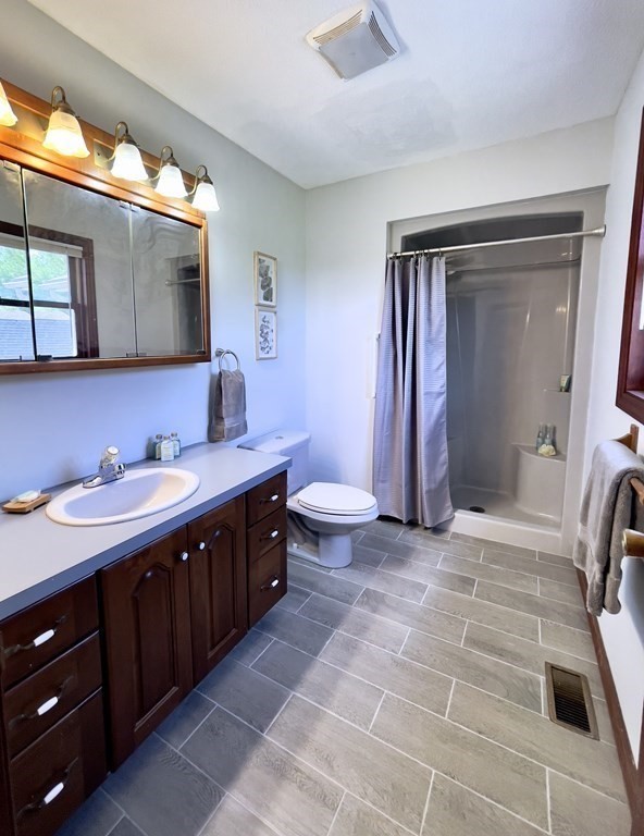 192 Hadley Road Sunderland, MA 01375 - Photo 16 of 30 a bathroom with a double vanity sink mirror and toilet