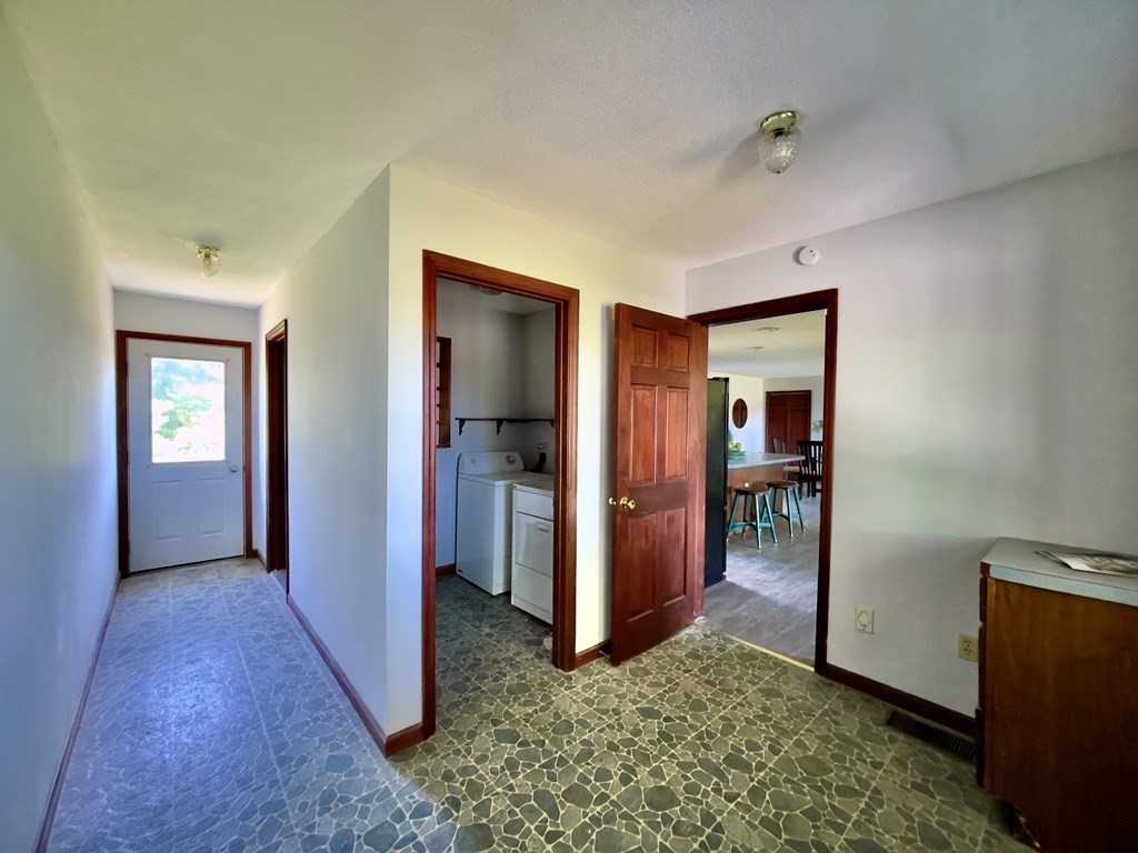 192 Hadley Road Sunderland, MA 01375 - Photo 18 of 30 a view of a hallway with bathroom and wooden floor