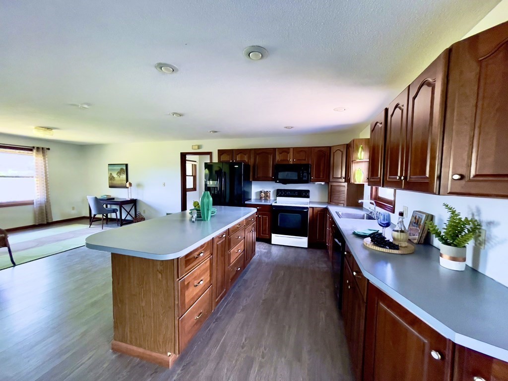192 Hadley Road Sunderland, MA 01375 - Photo 8 of 30 a kitchen that has a lot of cabinets a sink and wooden floor