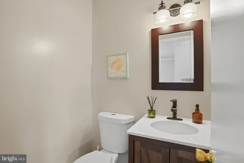 a bathroom with a sink a toilet and mirror