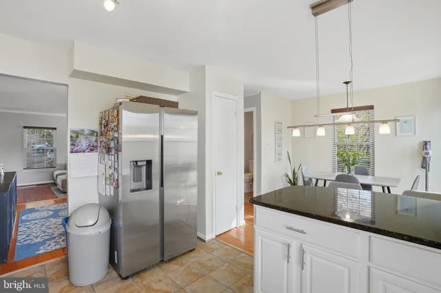 a kitchen with stainless steel appliances a sink a refrigerator a counter space and stainless steel appliances
