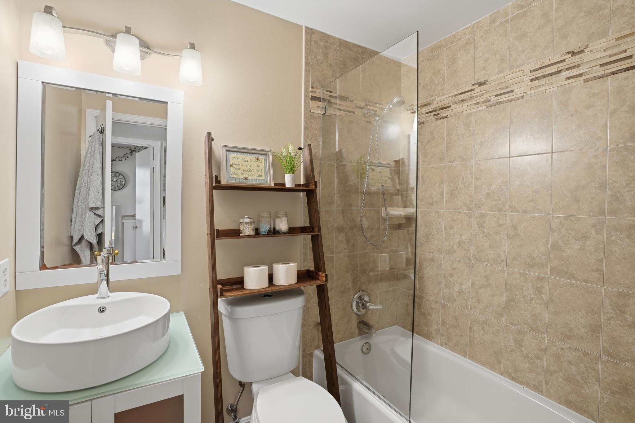 6172 Forest Creek Court Springfield, VA 22152 - Photo 25 of 42 a bathroom with a sink toilet a mirror and shower