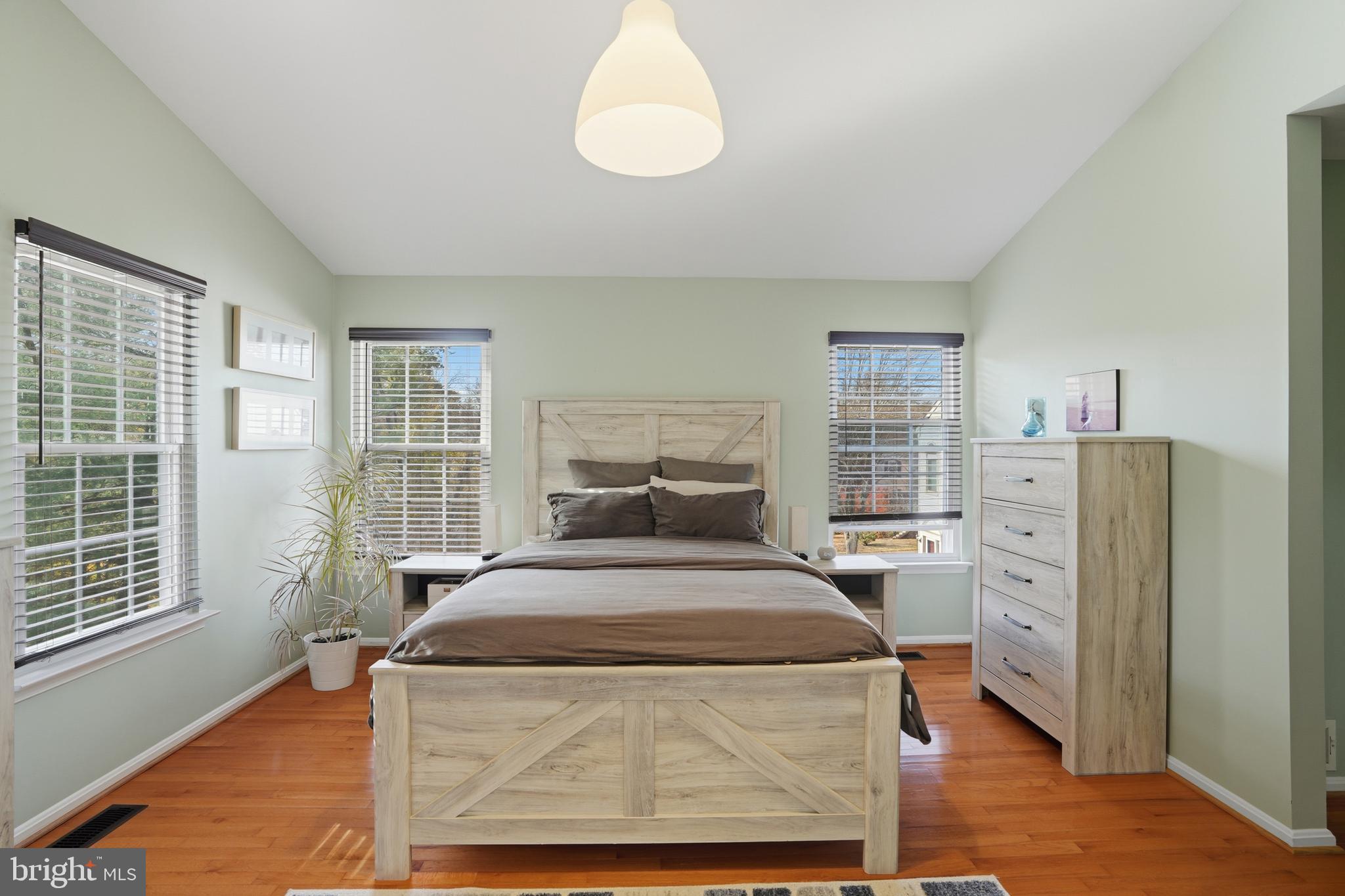 6172 Forest Creek Court Springfield, VA 22152 - Photo 27 of 42 a bedroom with a bed and wooden floor