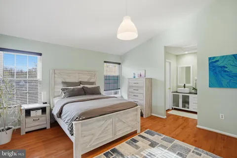 a bedroom with bed and wooden floor