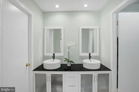 a bathroom with two sink and a mirror