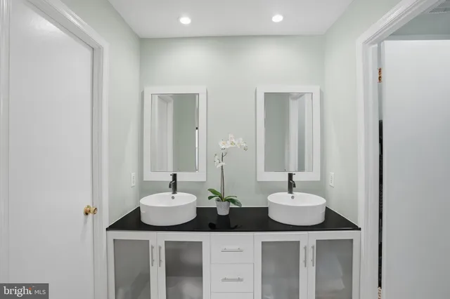 a bathroom with two sink and a mirror