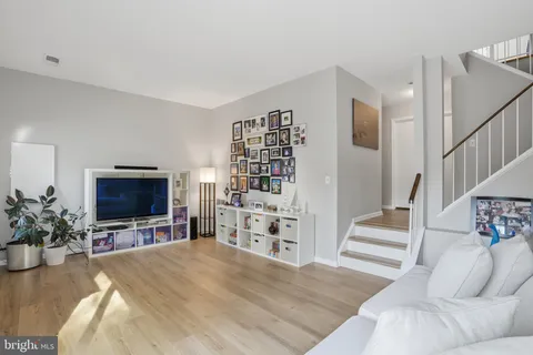 a view of a livingroom with furniture and staircase