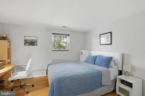 a bedroom with a bed and a desk