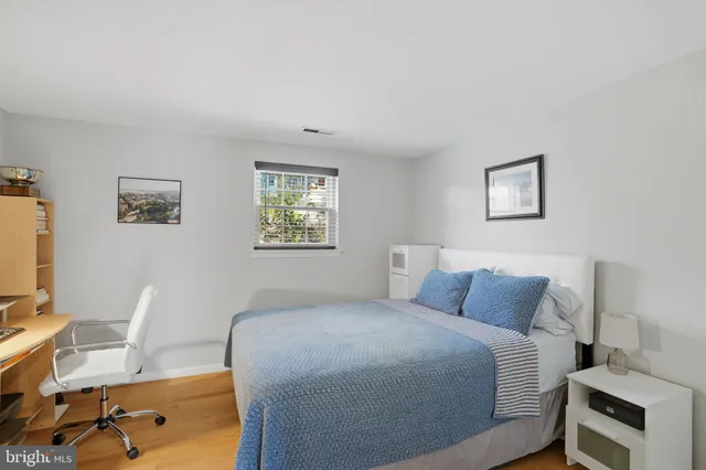 a bedroom with a bed and a desk