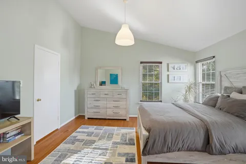 a bedroom with a bed and a television