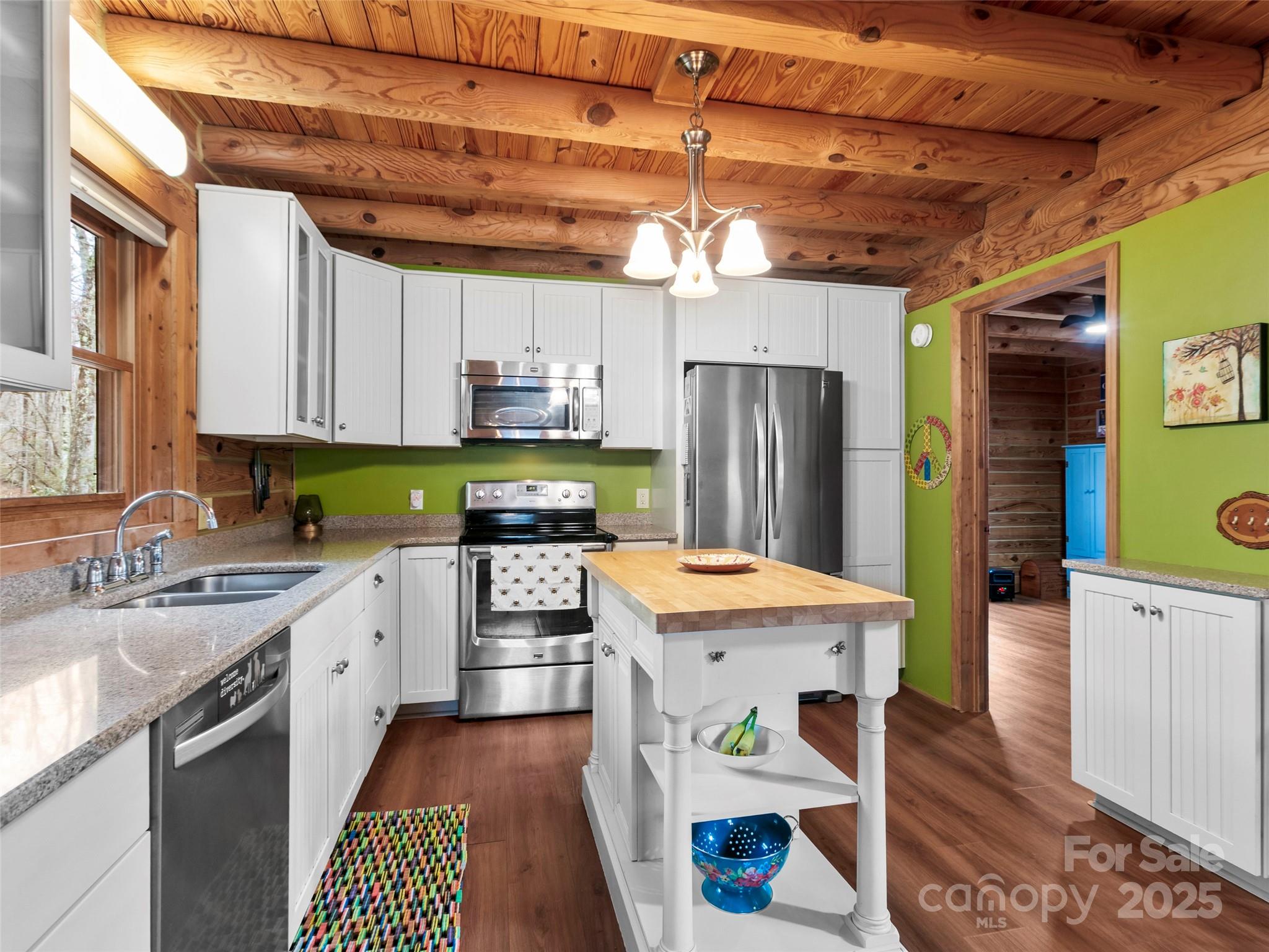 1239 Lower Loop Drive Fletcher, NC 28732 - Photo 11 of 24 a kitchen with stainless steel appliances granite countertop a sink stove and refrigerator