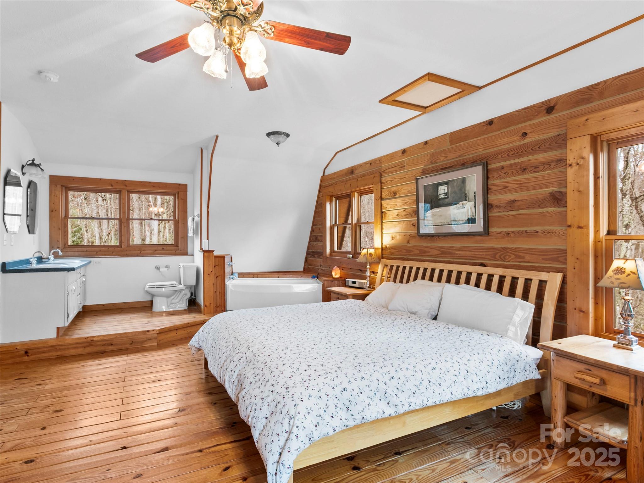 1239 Lower Loop Drive Fletcher, NC 28732 - Photo 15 of 24 a bedroom with a bed and wooden floor