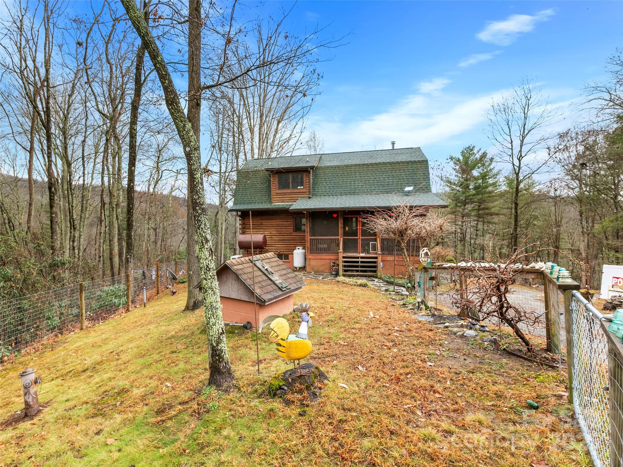 1239 Lower Loop Drive Fletcher, NC 28732 - Photo 21 of 24 a view of a patio with table and chairs with wooden fence and plants