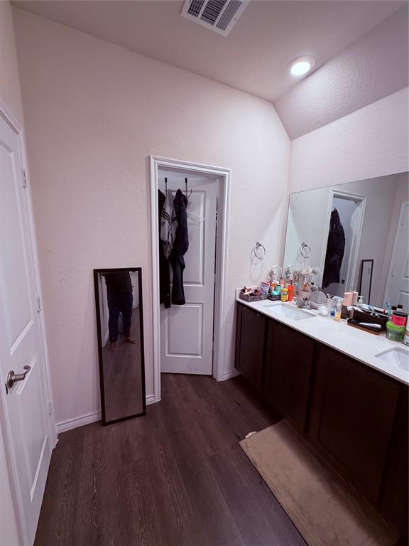 2001 Juniper Pass Way Mesquite, TX 75149 - Photo 12 of 12 Bathroom featuring dark wood-type flooring, double vanity, and vaulted ceiling