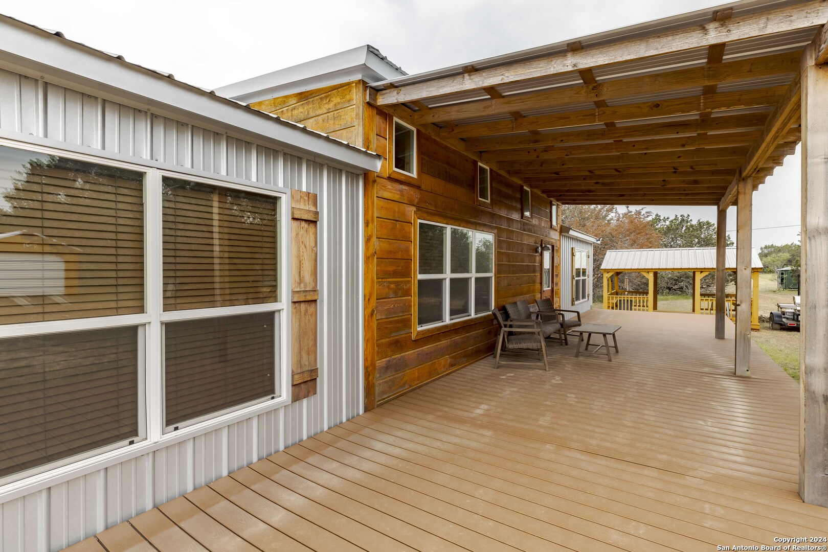 106 Homilius Road Comfort, TX 78013 - Photo 12 of 45 a view of a patio with a table and chairs and wooden floor