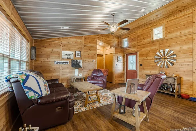 a kitchen with stainless steel appliances granite countertop sink stove refrigerator and wooden floor