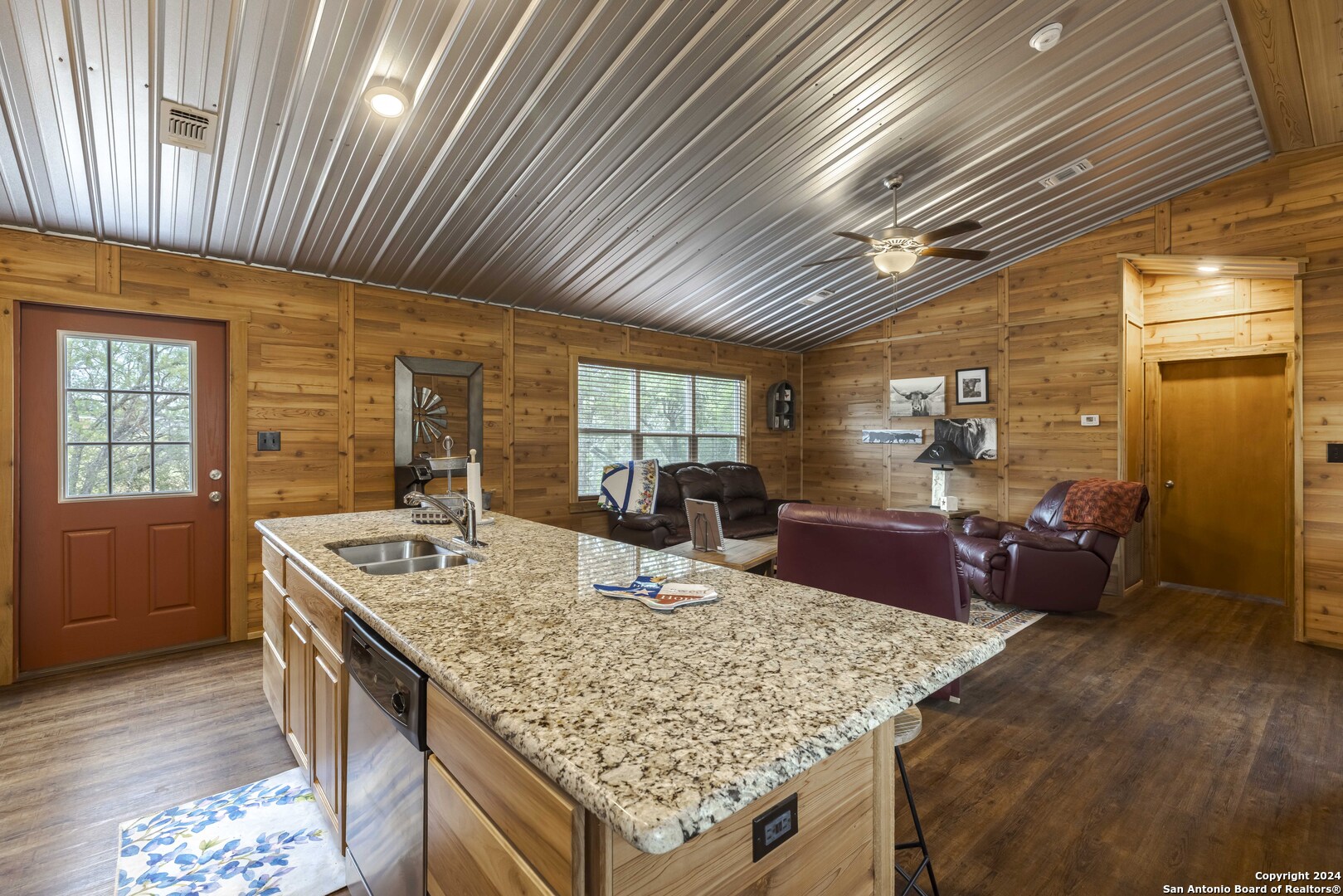 106 Homilius Road Comfort, TX 78013 - Photo 15 of 45 a kitchen with stainless steel appliances granite countertop sink stove refrigerator and wooden floor
