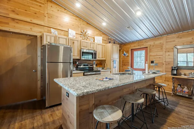 a kitchen with stainless steel appliances granite countertop a sink stove and granite counter top
