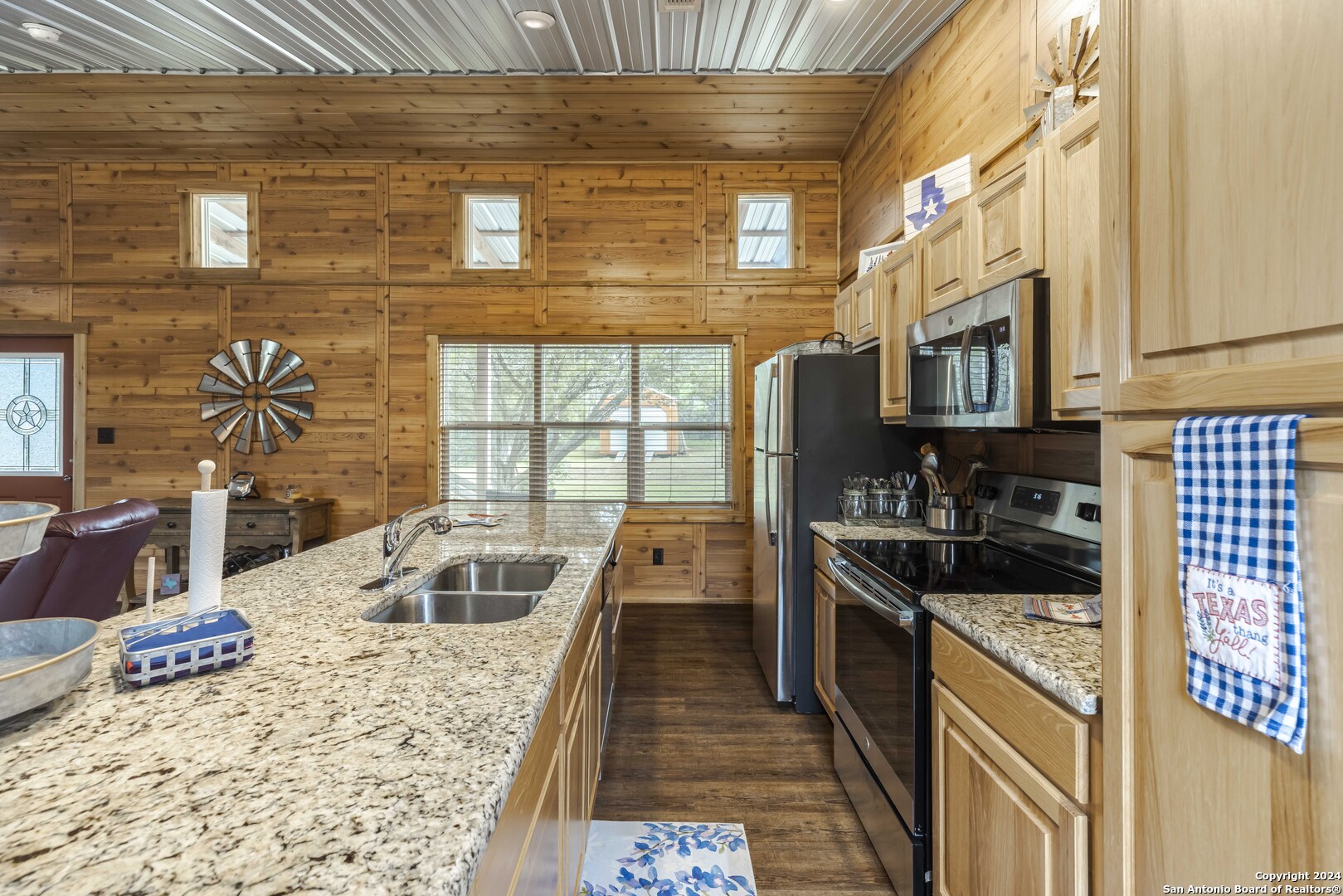 106 Homilius Road Comfort, TX 78013 - Photo 17 of 45 a kitchen with stainless steel appliances granite countertop a sink stove and granite counter top