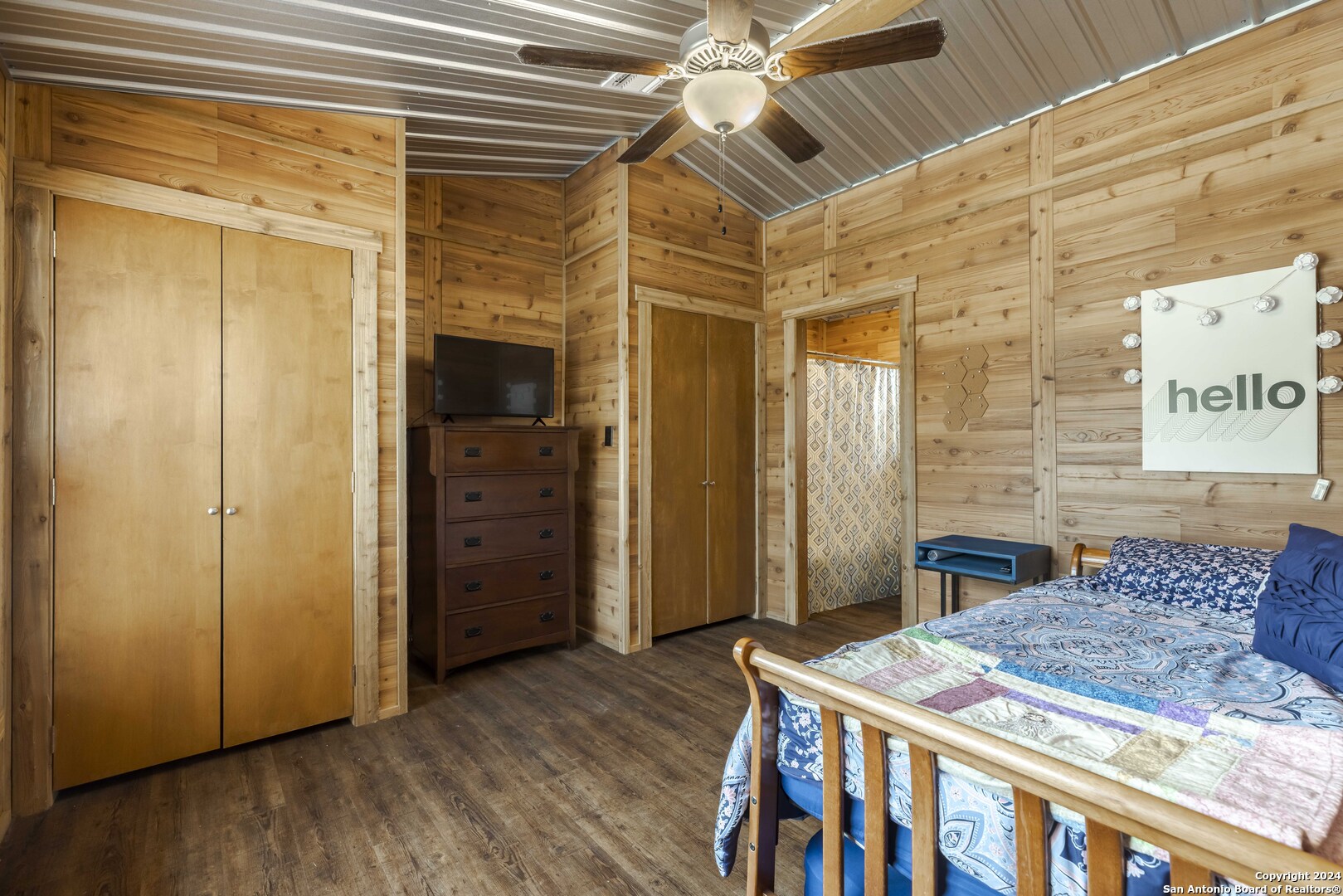 106 Homilius Road Comfort, TX 78013 - Photo 21 of 45 a bedroom with a bed and a chandelier