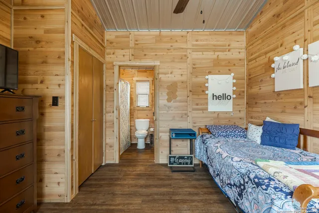 a bathroom with a granite countertop toilet a sink and a mirror