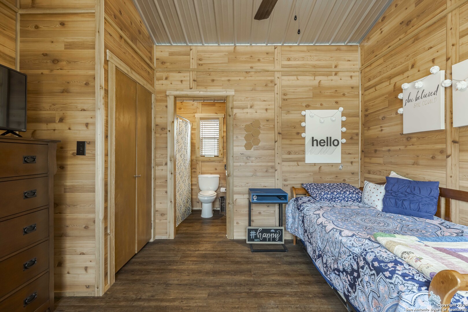 106 Homilius Road Comfort, TX 78013 - Photo 22 of 45 a spacious bedroom with a bed and a flat screen tv