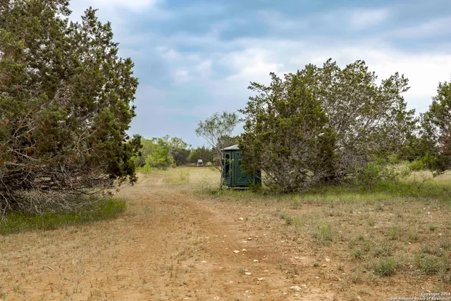 a backyard of a house with lots of green space and lake view