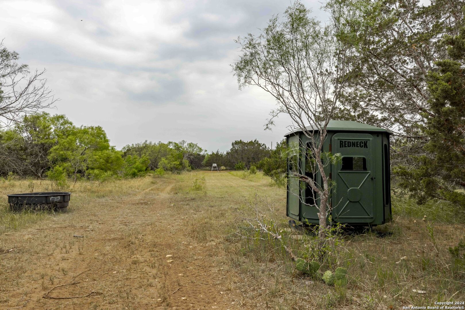106 Homilius Road Comfort, TX 78013 - Photo 28 of 45 a backyard of a house with lots of green space and lake view