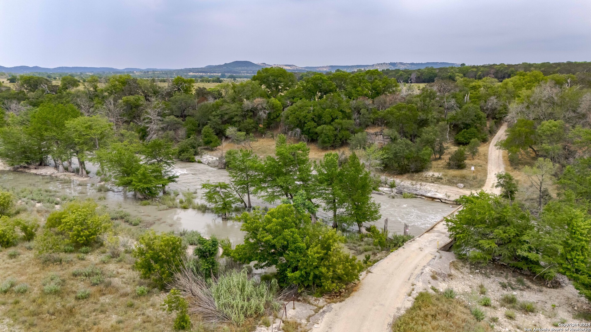 106 Homilius Road Comfort, TX 78013 - Photo 33 of 45 a view of a garden with a building in the background