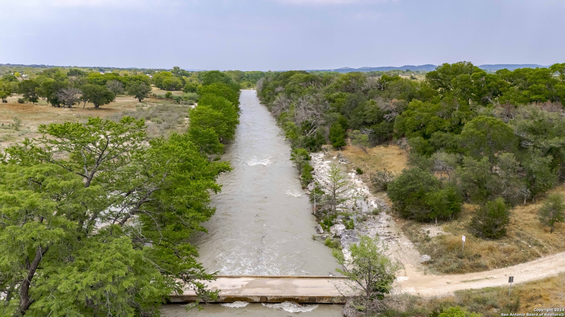 106 Homilius Road Comfort, TX 78013 - Photo 34 of 45 a view of a lake with a yard