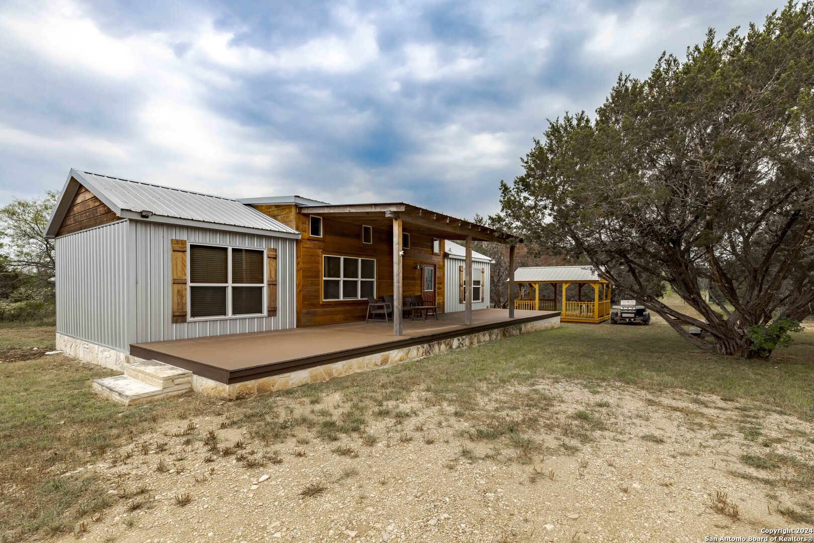 106 Homilius Road Comfort, TX 78013 - Photo 5 of 45 a front view of a house with garden