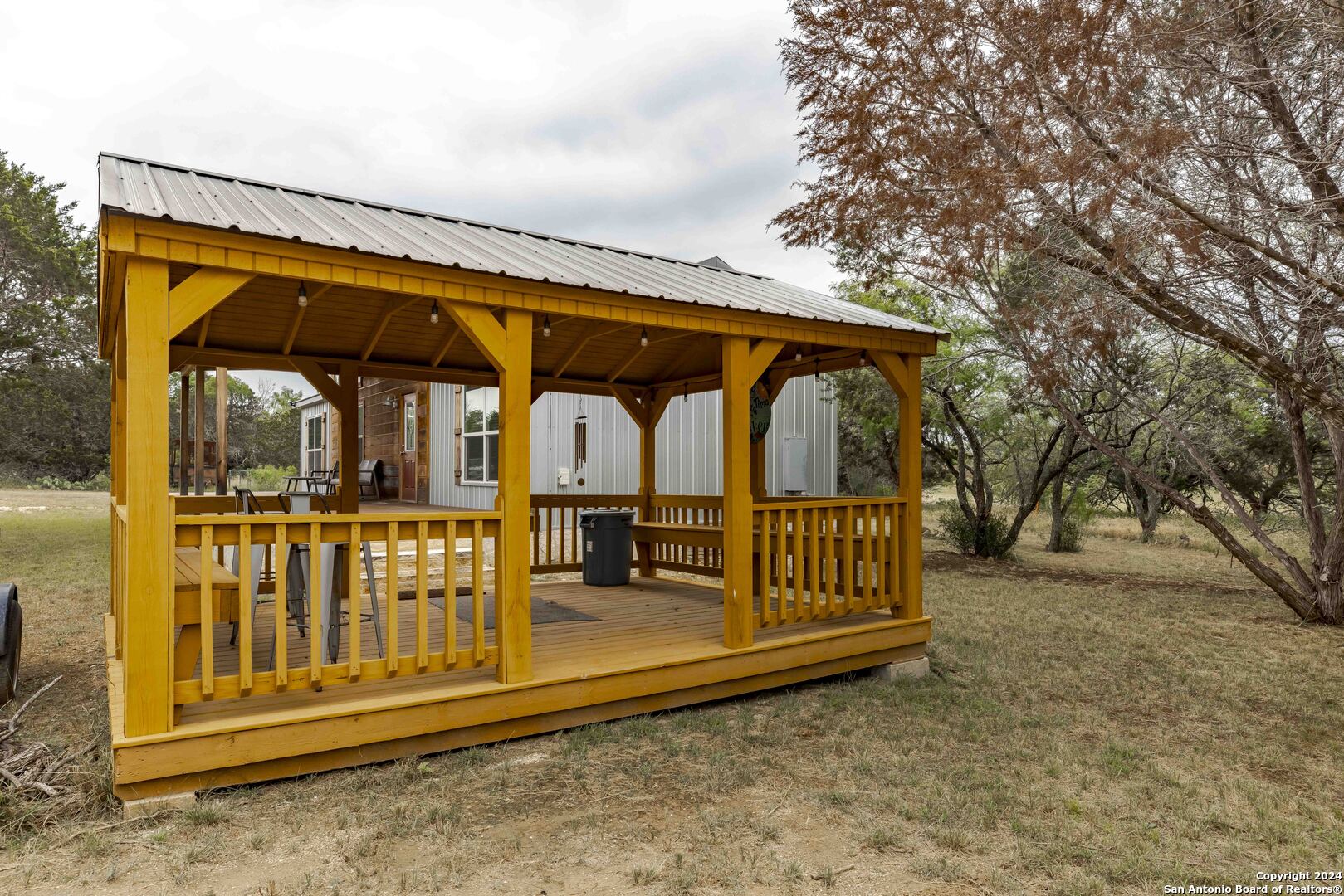 106 Homilius Road Comfort, TX 78013 - Photo 7 of 45 a view of porch with a small yard and wooden fence