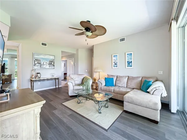 a living room with furniture or couch and a wooden floor