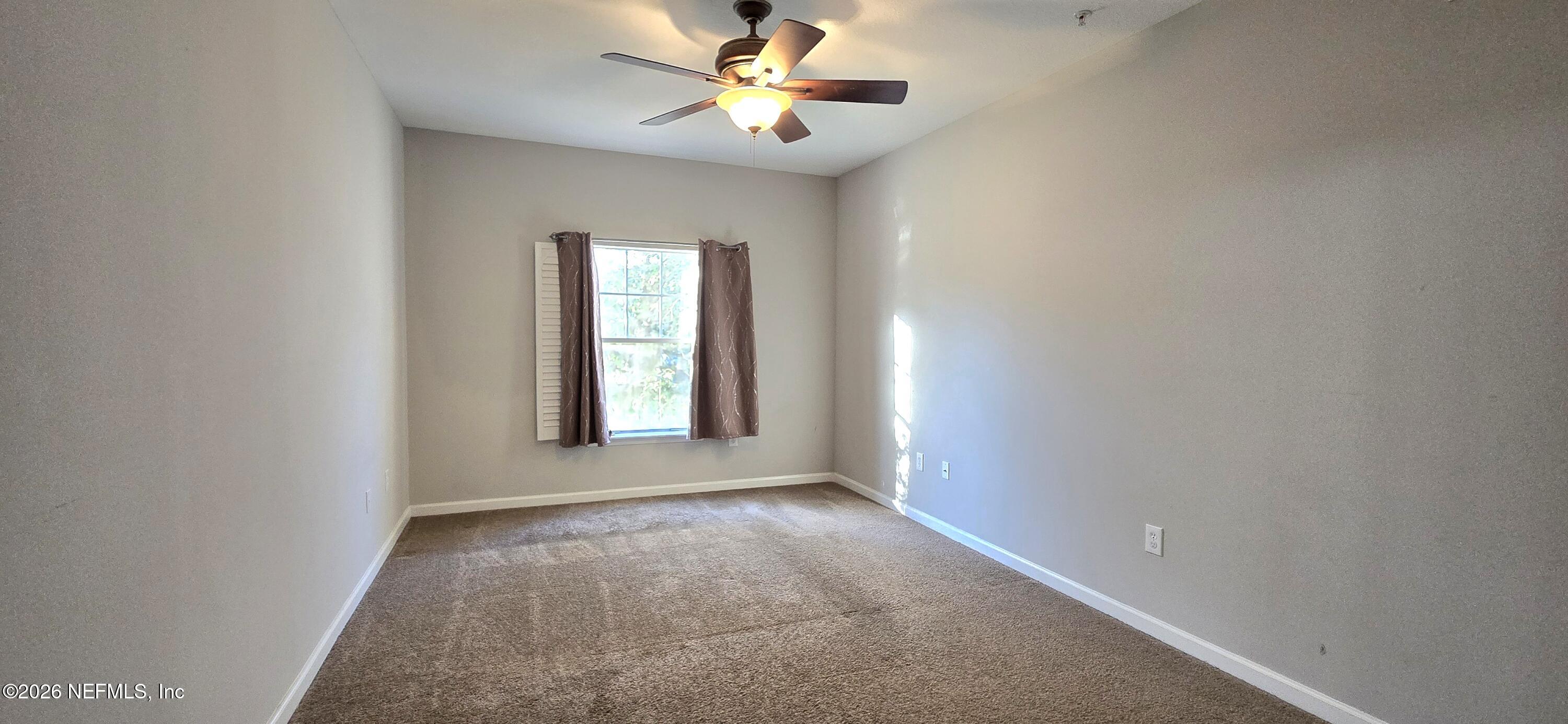8226 Green Parrot Road, Unit 206 Jacksonville, FL 32256 - Photo 11 of 20 a view of an empty room with a window