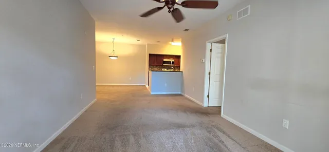 a view of a kitchen with a sink and a refrigerator