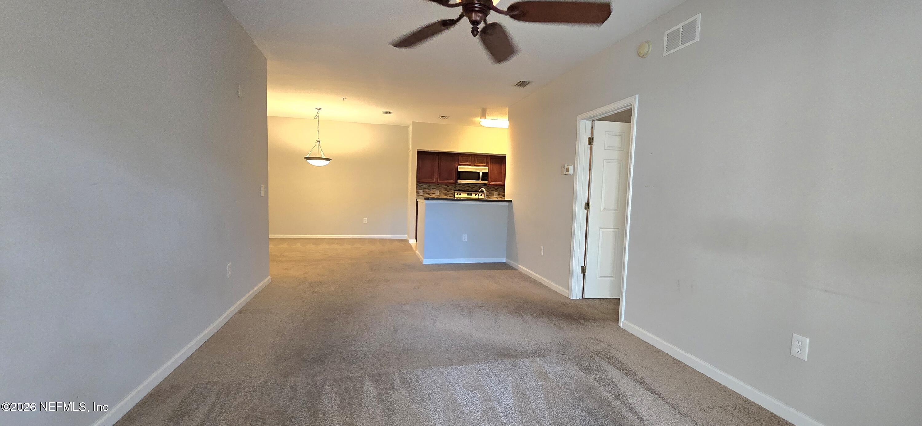 8226 Green Parrot Road, Unit 206 Jacksonville, FL 32256 - Photo 12 of 20 a view of a livingroom with a chandelier