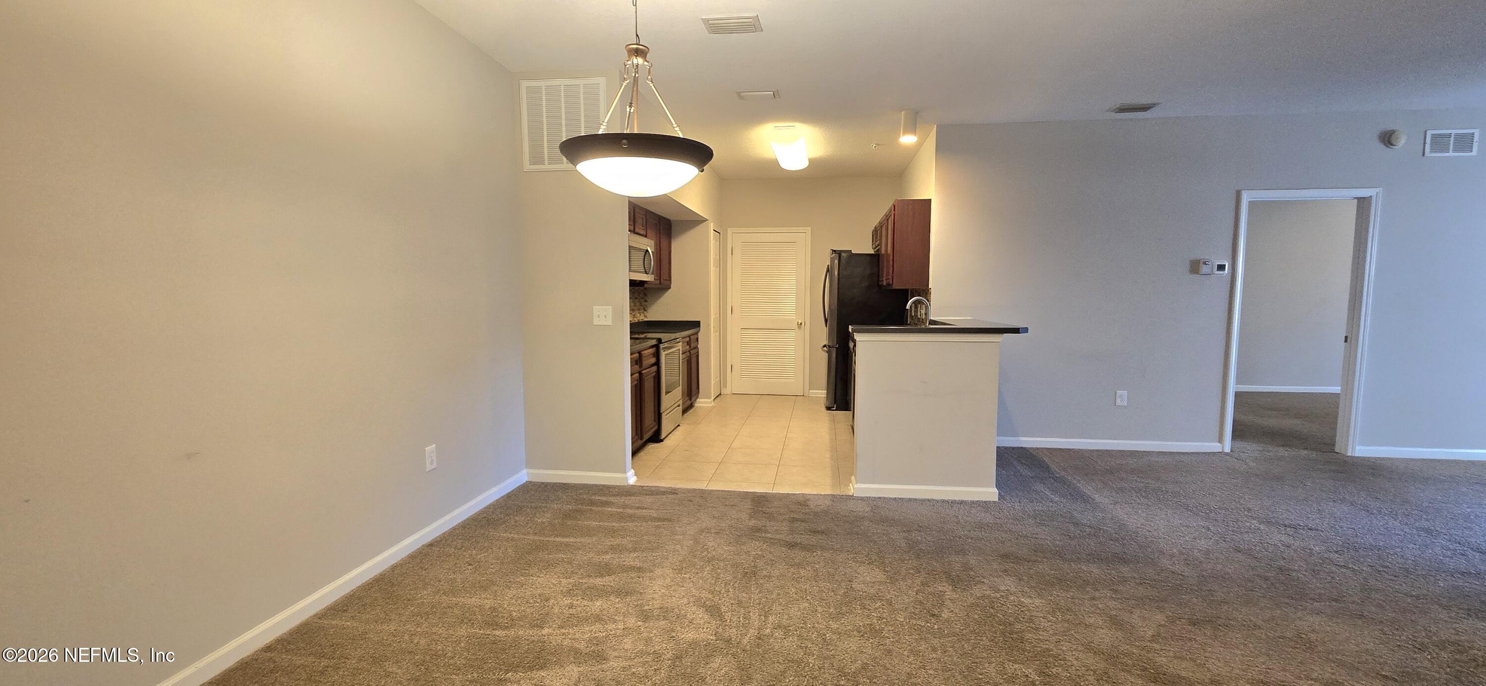 8226 Green Parrot Road, Unit 206 Jacksonville, FL 32256 - Photo 14 of 20 a view of a kitchen with a sink and a refrigerator