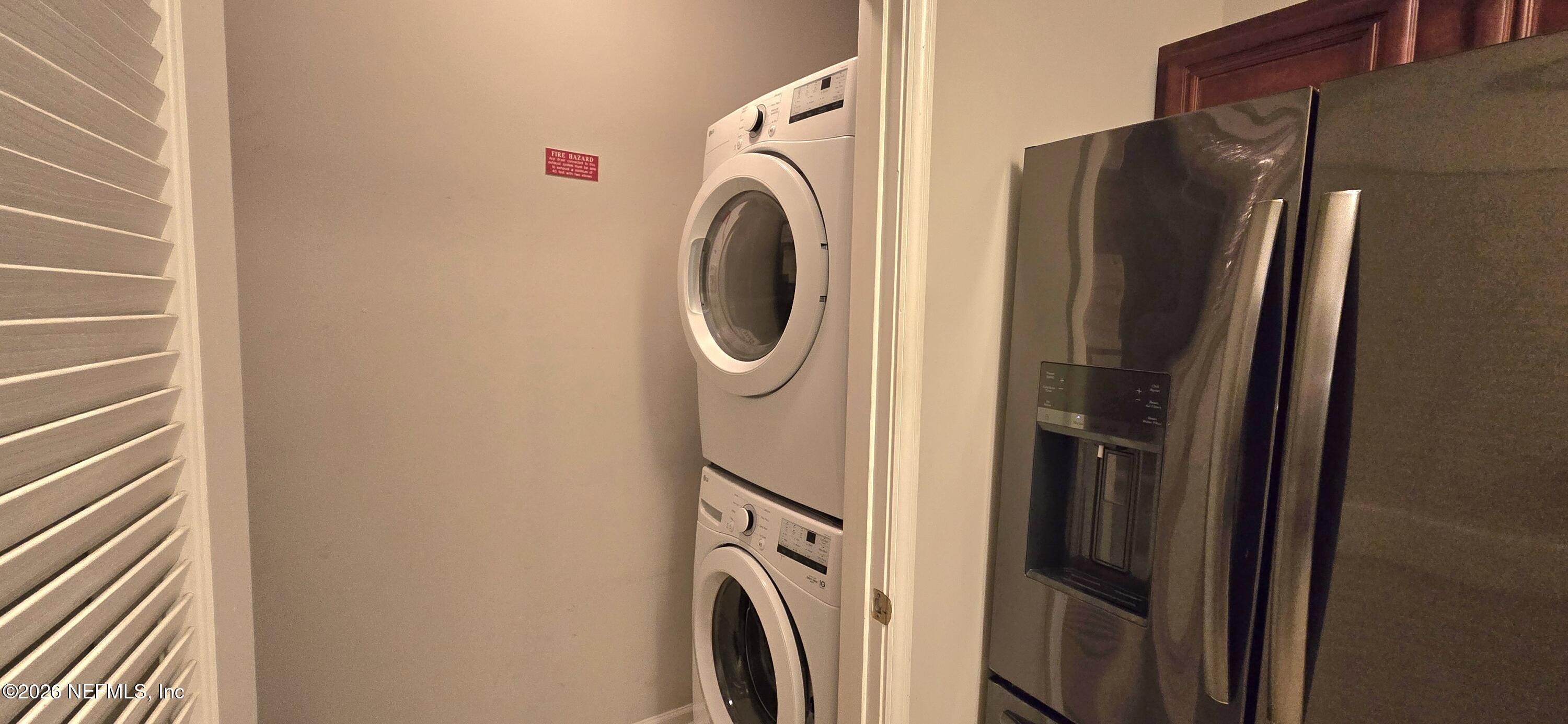 8226 Green Parrot Road, Unit 206 Jacksonville, FL 32256 - Photo 18 of 20 a utility room with dryer and washer