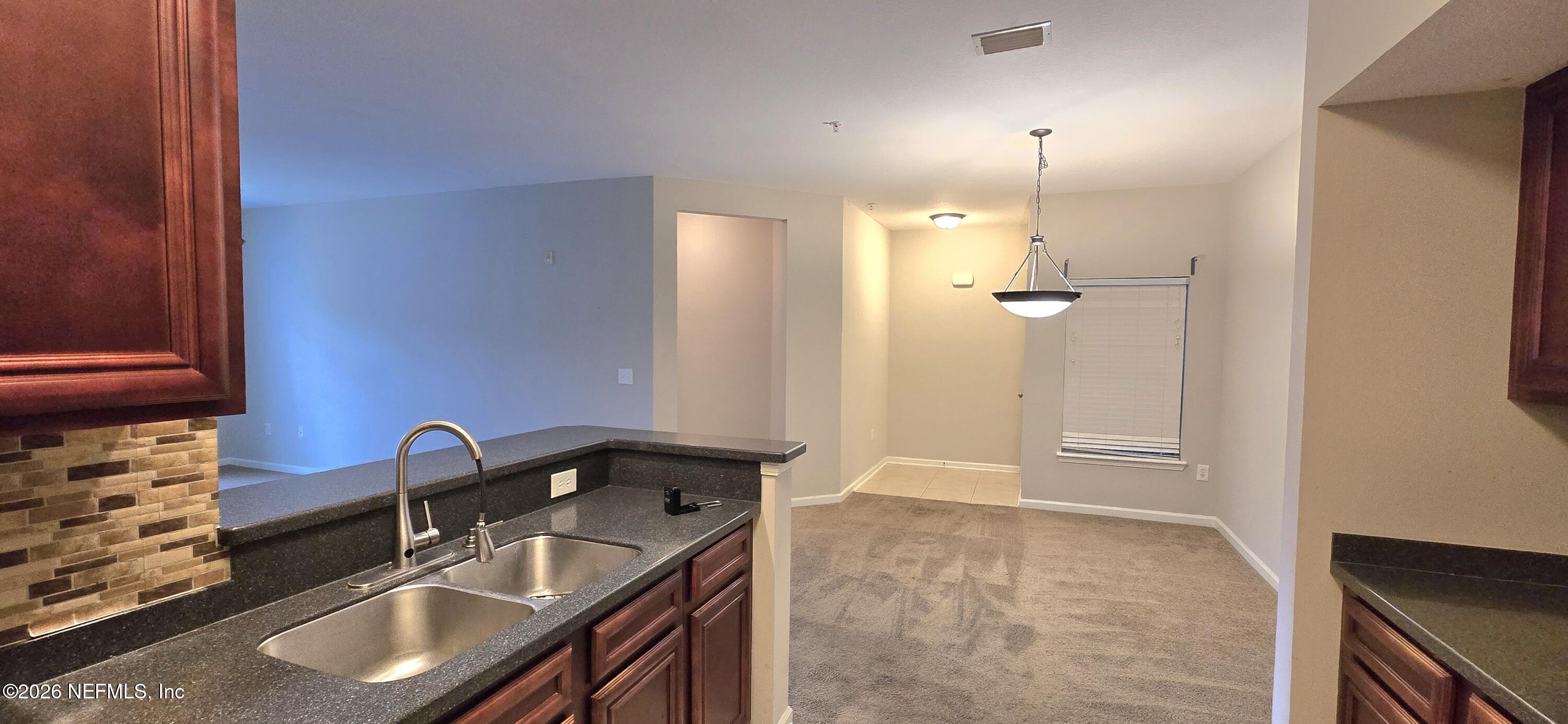 8226 Green Parrot Road, Unit 206 Jacksonville, FL 32256 - Photo 20 of 20 a bathroom with a sink and a mirror
