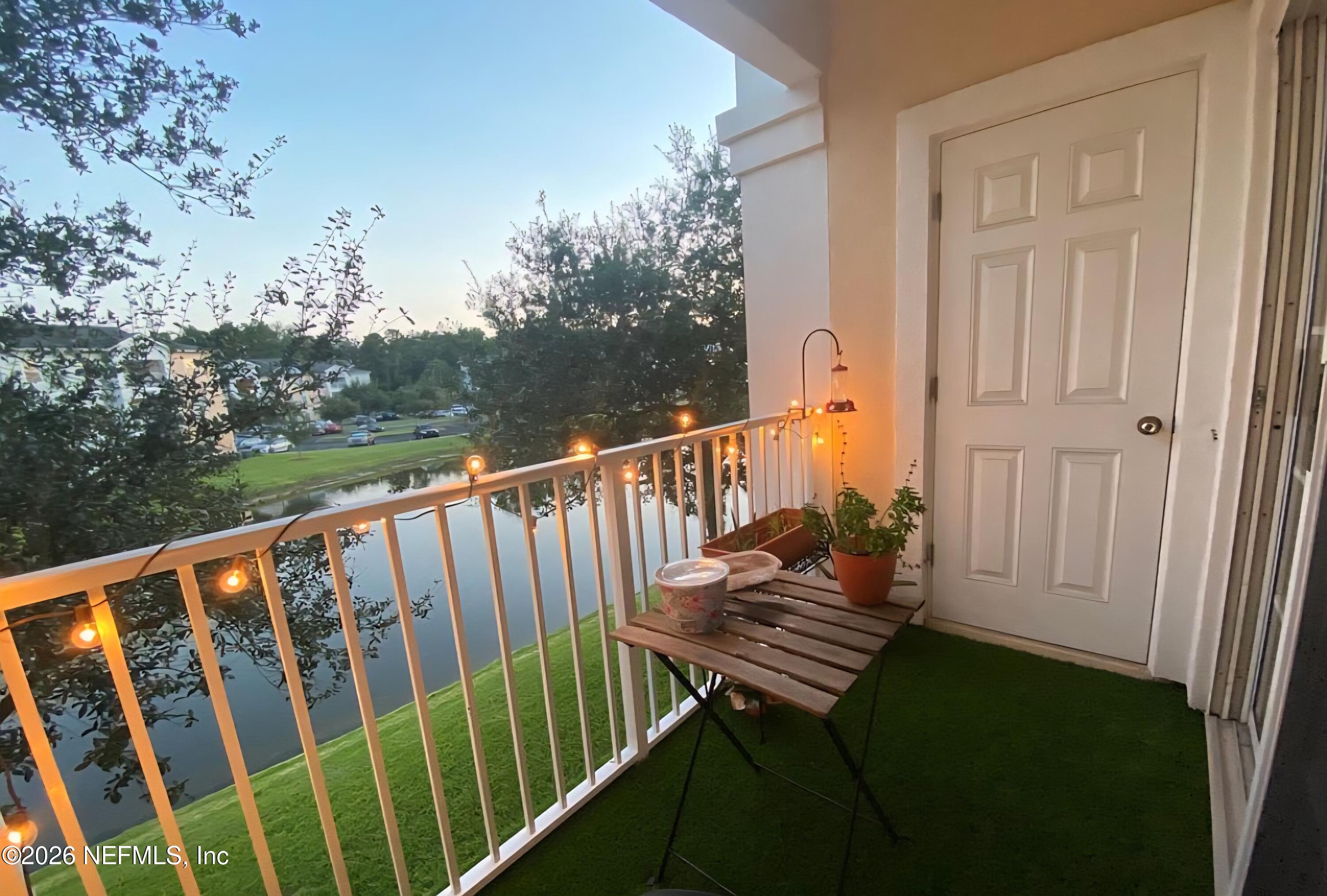8226 Green Parrot Road, Unit 206 Jacksonville, FL 32256 - Photo 3 of 20 a view of balcony with wooden floor and fence