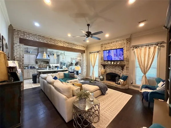 a living room with furniture fireplace and a large window