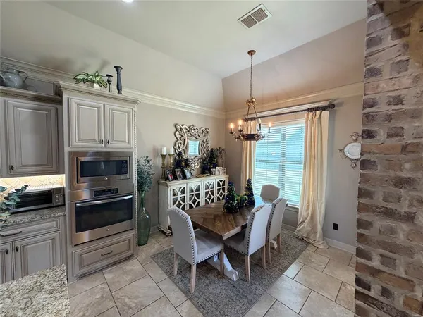 a dining room with furniture and window
