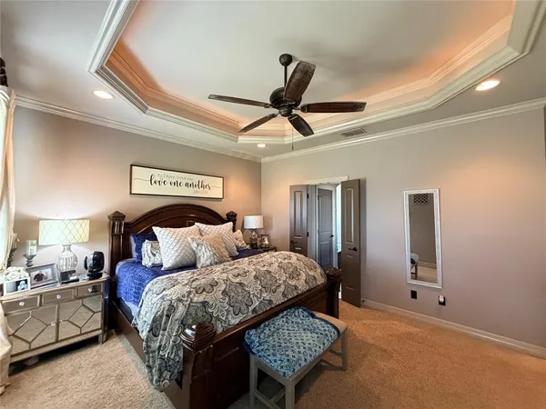 a bedroom with a bed and a ceiling fan