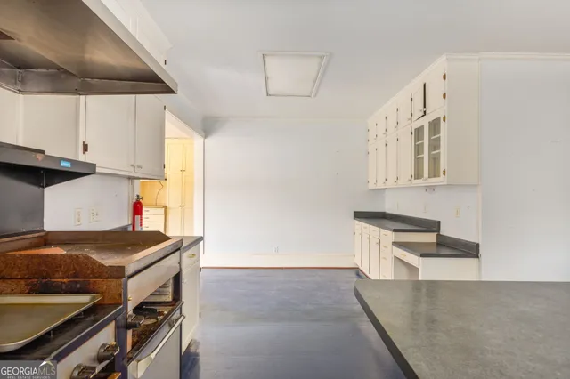 a kitchen that has a stove and a microwave