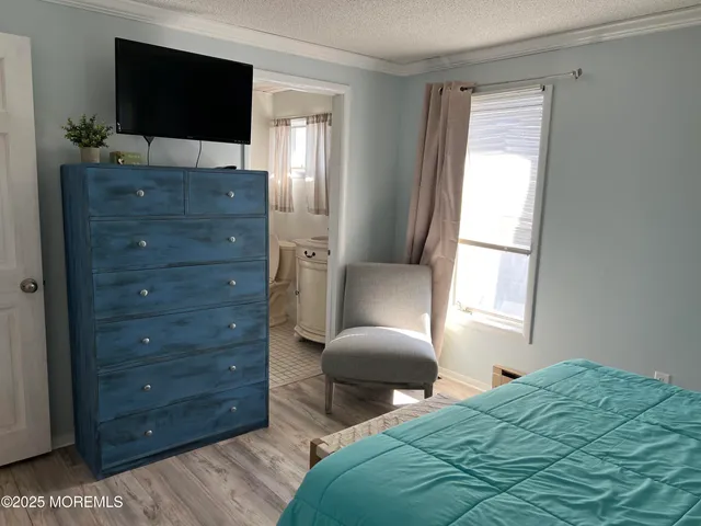 a bedroom with a bed and a television