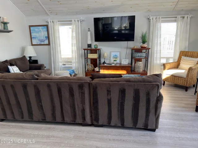 a living room with furniture fireplace and flat screen tv